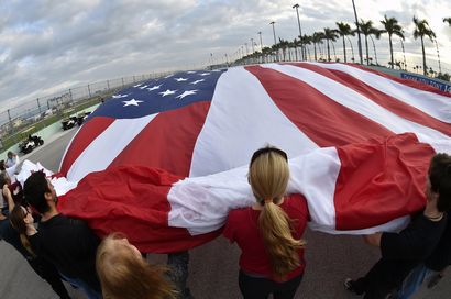 workers unfurling 45 by 92-foot American flag