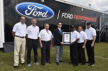 Edsel Ford and Ford employees with Guinness World Records plaque