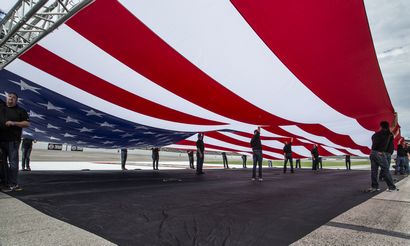 workers lifting 40 by 80-foot American flag during Chevy's run